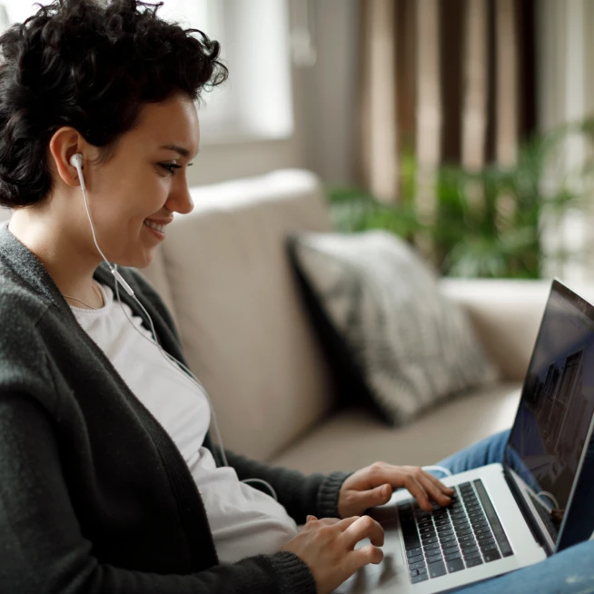 A young lady is browsing the laptop for online shopping powered by Brightspeed home internet.