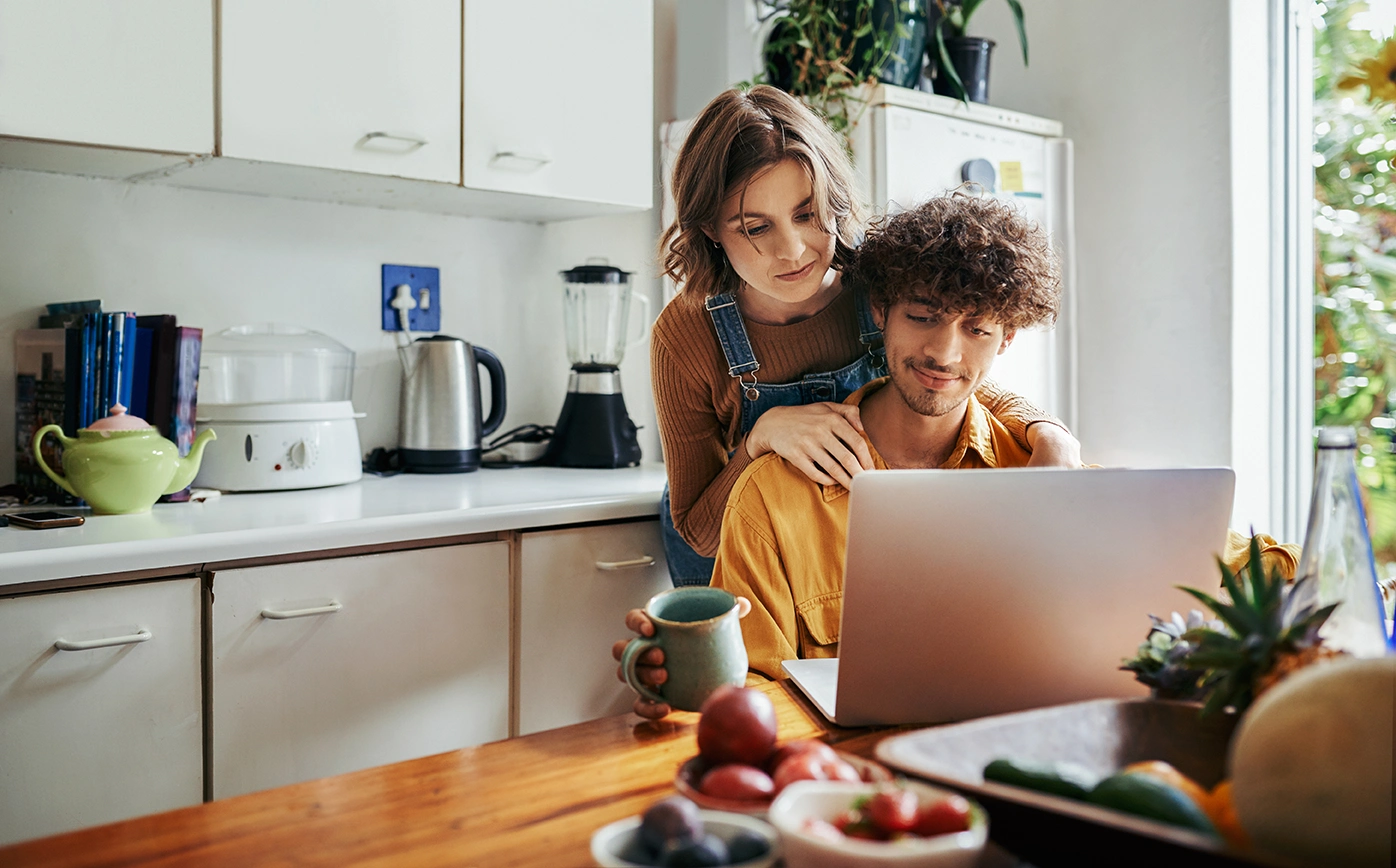 Young Couple Looking at Laptop